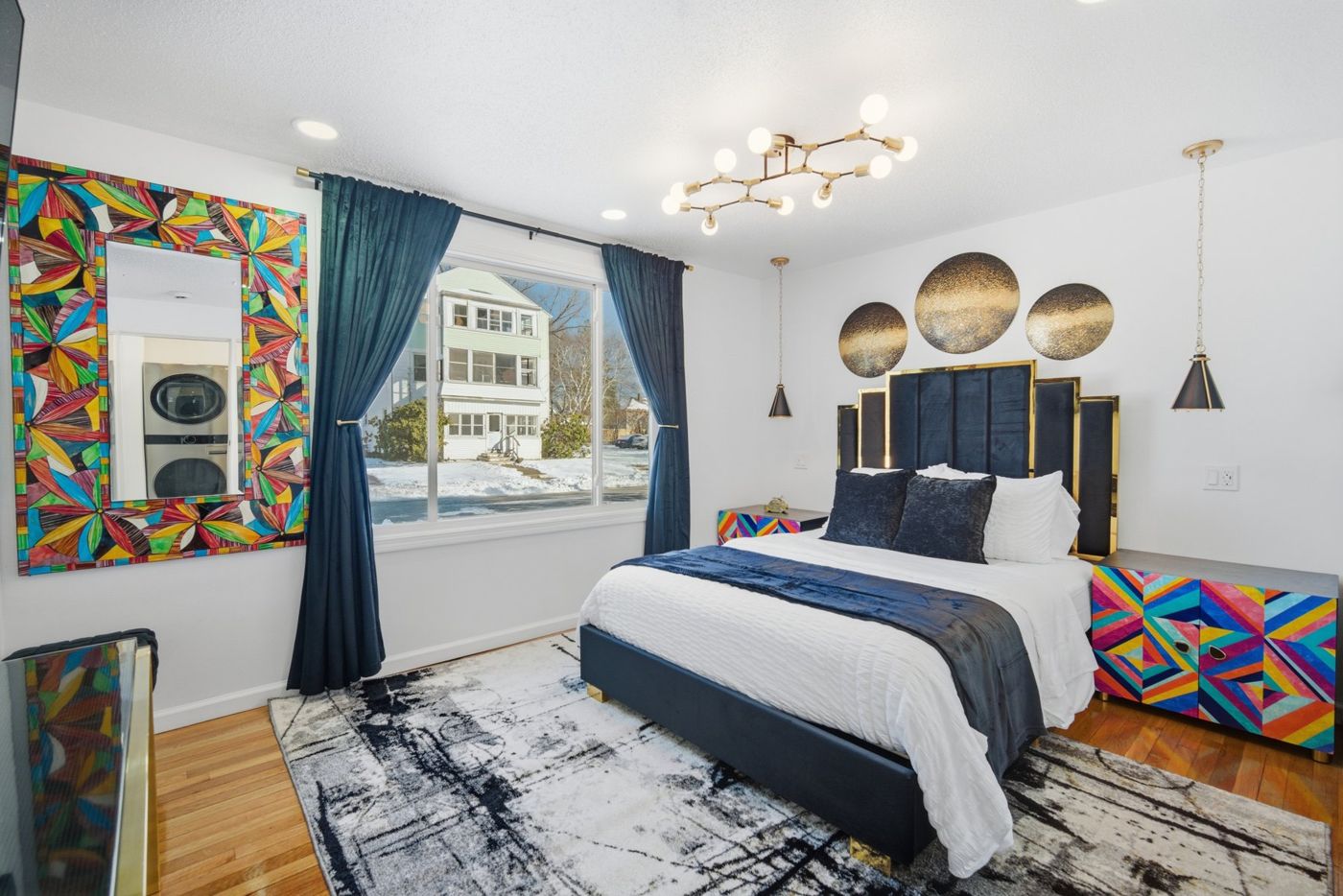 Styled vacation rental bedroom with bold accent decor