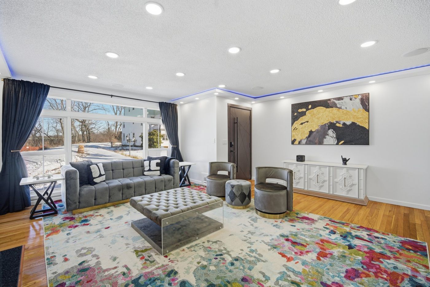 Short-term rental living room with fireplace and bold area rug